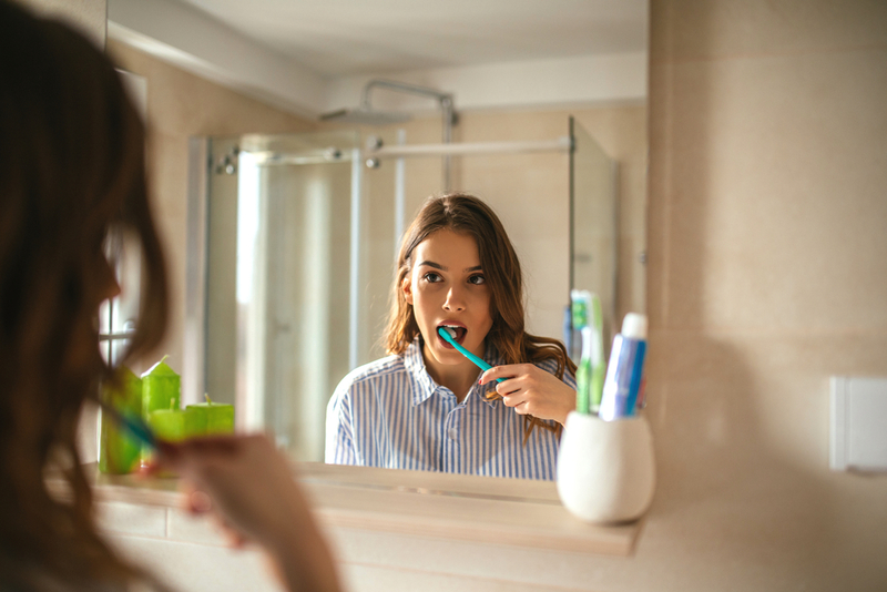Using a Worn-Out Toothbrush | Shutterstock