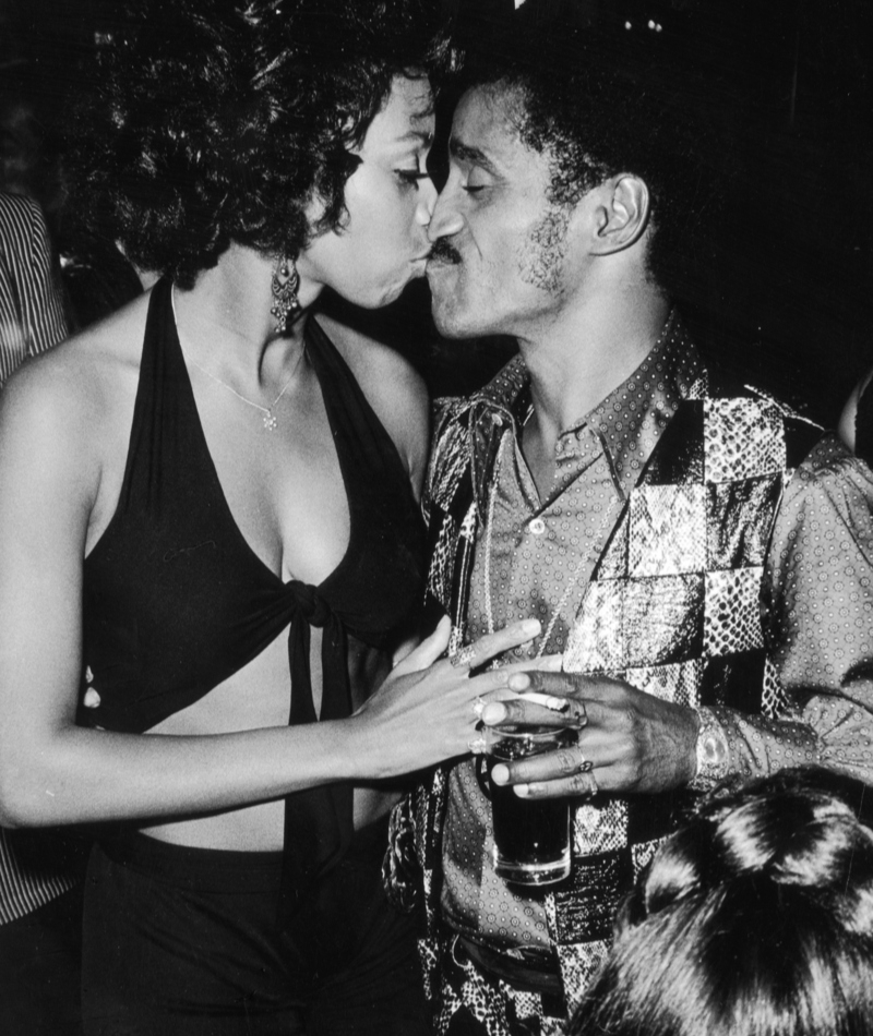 Sammy Davis Jr. und seine Frau werden auf einer Party romantisch | Getty Images Photo by Darlene Hammond/Hulton Archive